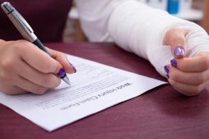 Accident victim completing claim form while looking for a personal injury lawyer in Bridgeport